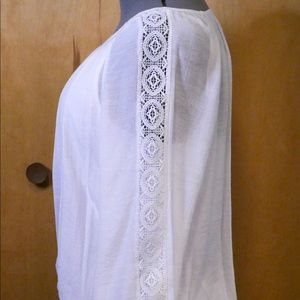 JM Collection white top with crocheted design on sleeves.